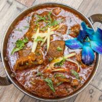 Home Style Goat Curry · Soft, tender chunks of lamb meat in a Indian onion tomato gravy.