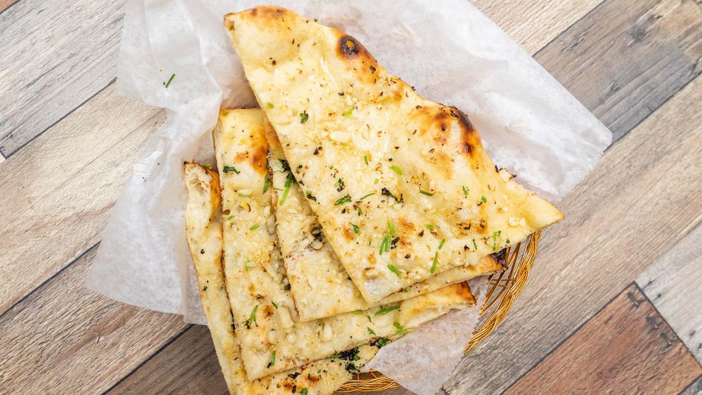Garlic Naan · Made to order naan that is crispy and soft, fresh from the tandoor.