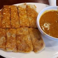 Roti Telor · Hot & Spicy. A traditional Indian pancake filled with egg and onion served with curry sauce.