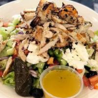Classic Greek Salad · Iceberg lettuce, tomatoes, red onions, green peppers, black olives, crumbled feta, stuffed g...