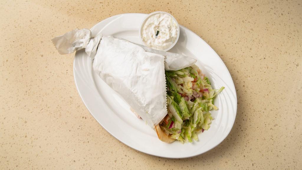 Gyro Sandwich · Meat or chicken souvlaki on pita bread with lettuce, tomato, onion and tzatziki sauce. 
( NOT  SERVED WITH A GREEK SALAD ON THE SIDE)