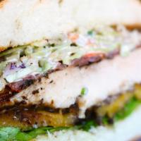 Jamaican Jerked Chicken · Grilled chicken with jerk spice, plantains, lemon slaw on roll.