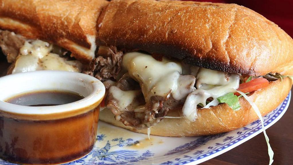 The Dobbs Dip · Not-so-traditional steak sandwich with melted Swiss, caramelized onions, and horseradish sauce.