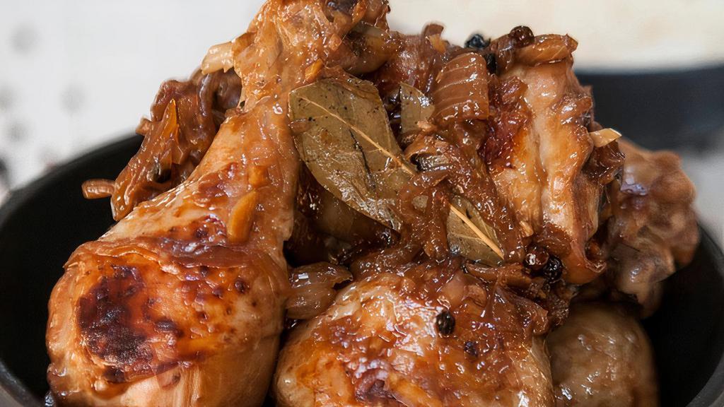 Adobo Chicken · Stewed chicken in soy sauce, vinegar, garlic with whole black pepper, onion, and bay bay leaves