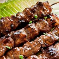 Pork Bbq · Filipino-style pork BBQ. Two sticks with rice.