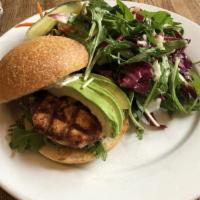 Grilled Salmon Burger · made in house with wild organic salmon, served with avocado, arugula, wasabi mayo, and a sid...