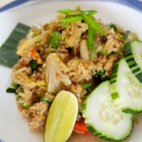 Thai Fried Rice · Classic Thai fried rice with onions, tomatoes, scallions and egg with light soy sauce.