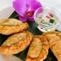 Curry Puff · Minced chicken, potatoes and onions cooked with curry powder and served with sweet cucumber ...