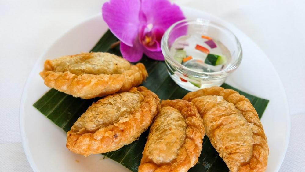 Curry Puff · Minced chicken, potatoes and onions cooked with curry powder and served with sweet cucumber relish.
