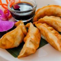 Gyoza · Pork dumplings. Fried ground pork with vegetables. Served with sweet soy sauce.