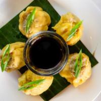 Steamed Dumplings · Ground chicken and shrimp, water chestnuts and shiitake mushrooms served with tangy soy sauce.