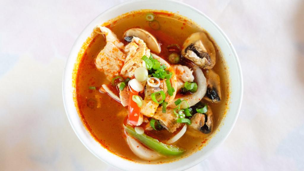 Tom Yum Soup · *Spicy* thai traditional. A spicy soup with lime juice, chili paste, mushrooms, red bell peppers, onion, galanga, lemongrass, kaffir leaves, and herbs.