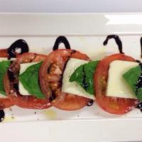 Caprese Salad · Fresh mozzarella, basil and tomatoes. Extra virgin olive oil.