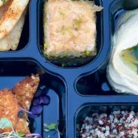 Schnitzel Bento Box · Schnitzel with hummus, pita and your choice of meze, choice of side and choice of dessert.