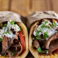 Lamb Gyro · comes on pita bread with lettuce tomato grilled onions and white tzatziki sauce.