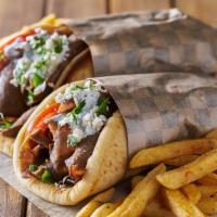 Lamb Gyro · Delicious Gyro made with Lamb, Peppers, onions, lettuce, tomato, hot sauce, and white sauce.