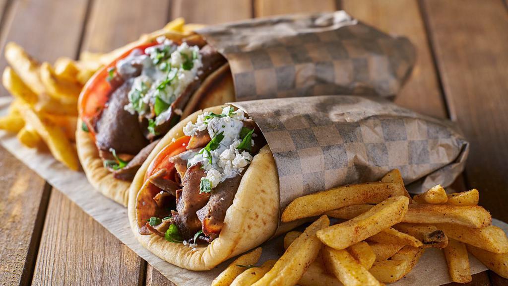 Lamb Gyro · Delicious Gyro made with Lamb, Peppers, onions, lettuce, tomato, hot sauce, and white sauce.