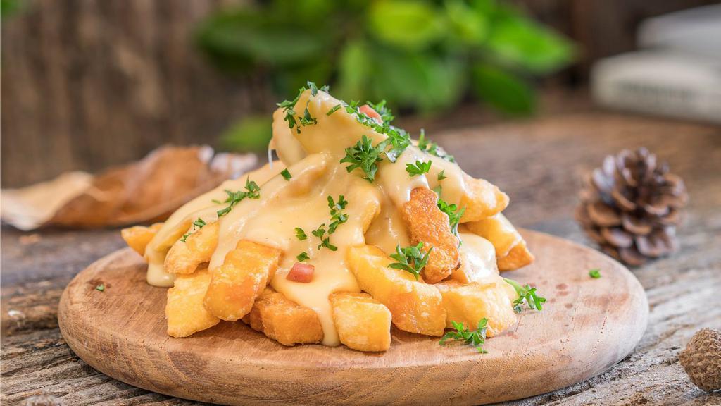 Cheese Fries · Golden-crispy fries salted to perfection, topped with melted cheese.