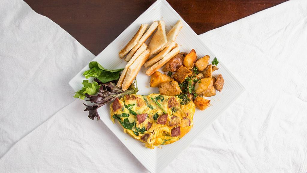 Sujuk Spinach Omelette · Sujuk (dried Mediterranean sausage), baby spinach, and goat cheese. Served with home fries and toast.
