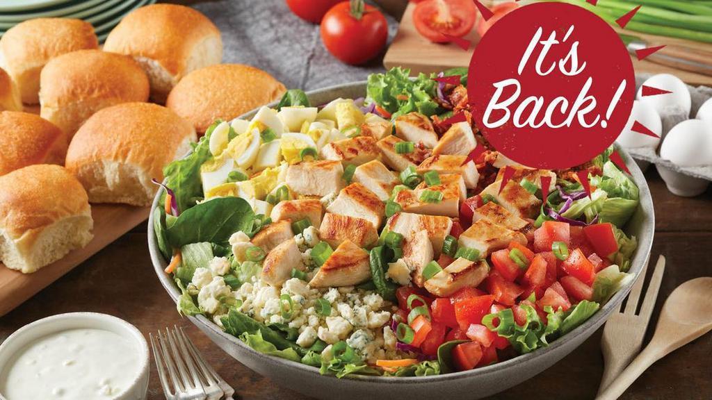 Family Size Grilled Chicken Cobb Salad · Grilled chicken, crispy bacon, hard boiled eggs, fresh-diced tomatoes and green onions on a bed of greens, topped with real blue cheese crumbles.