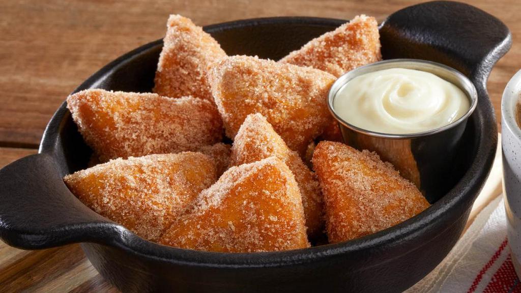 Cinna-Biscuits · Eight pieces of made-to-order fried biscuit dough dusted with cinnamon sugar and served with warm cream cheese icing