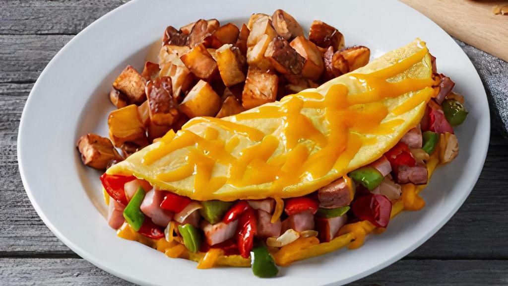 Western Omelet · Filled with hickory-smoked ham, sautéed onions, red & green bell peppers and cheddar cheese. Served with hash browns or home fries  and freshly-baked biscuits