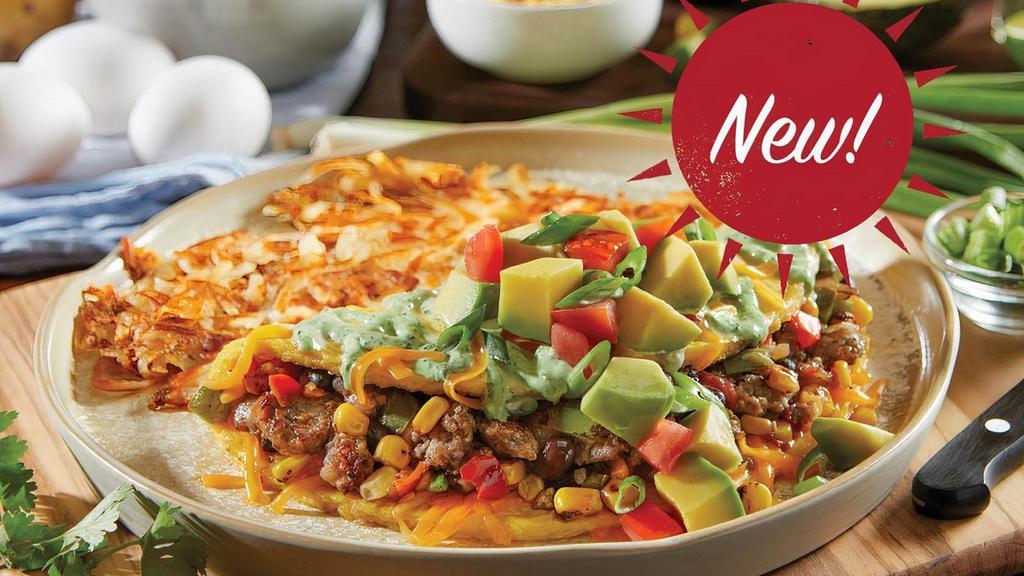 Southwest Avocado Omelet · Three-egg omelet filled with farm-famous sausage, fire-roasted corn & black beans and cheddar cheese. Topped with fresh avocado, diced tomatoes, green onions and cilantro lime cream sauce. Served with hashbrowns, home fries or fresh-cut fruit and freshly-baked biscuits
