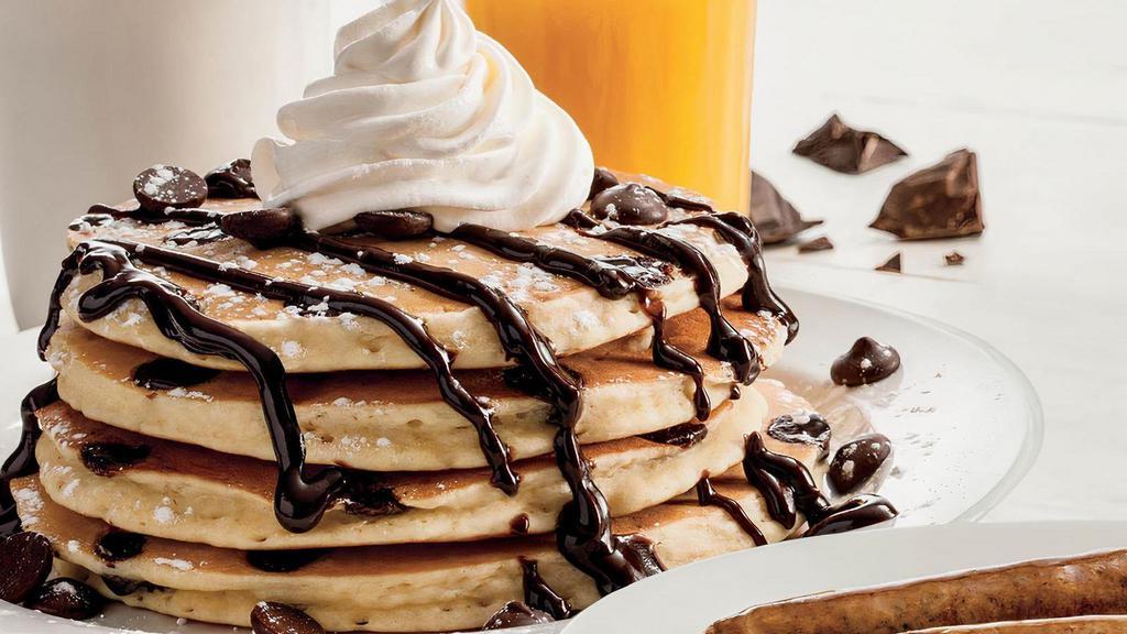 Double Chocolate Hotcakes · Four chocolate chip-loaded hotcakes topped with chocolate chips, chocolate sauce, whipped topping and powdered sugar. Served with your choice of premium breakfast meat or fresh fruit