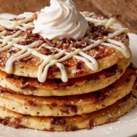 Cinnamon Supreme Hotcakes · Four cinnamon chip hotcakes topped with cream cheese icing, whipped topping and powdered sug...