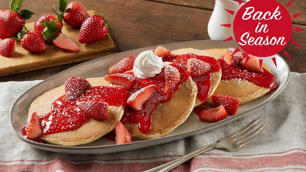 Fresh Berry Hotcakes · Four buttermilk hotcakes topped with vine-ripened strawberries, strawberry sauce, powdered sugar and whipped topping. Served with your choice of premium breakfast meat or fresh fruit.