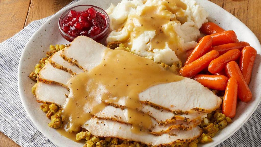 Slow-Roasted Turkey & Dressing · Slow-roasted in the kitchen for hours with our savory blend of herbs and spices. Served with bread & celery dressing, homestyle gravy, cranberry relish, choice of two sides and dinner rolls