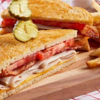 Slow-Roasted Turkey Bacon Melt · Slow-roasted shaved turkey topped with American cheese, tomato and bacon on grilled sourdoug...