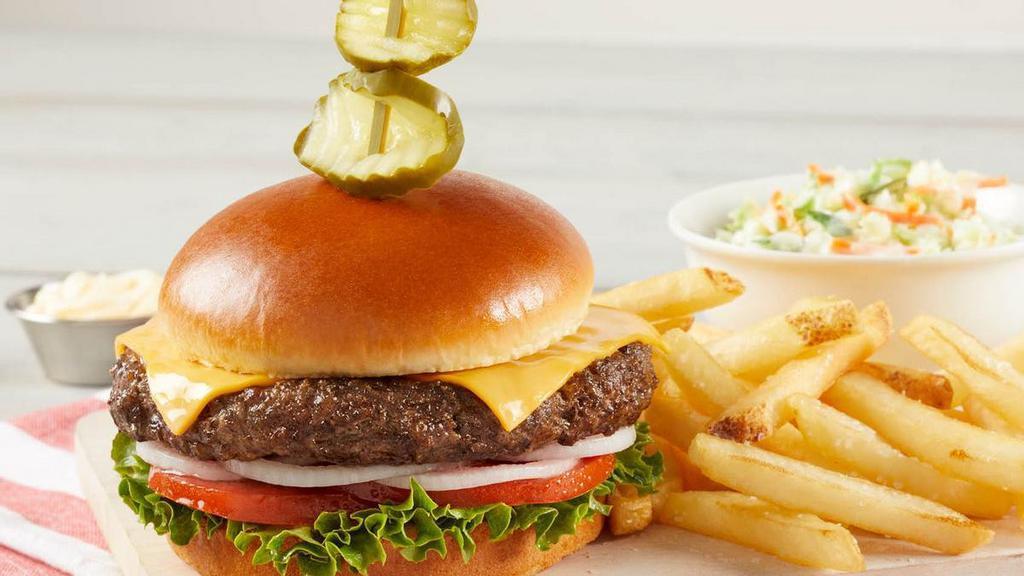 Cheeseburger · 100% black Angus beef topped with lettuce, tomato, onion and garnished with deli pickles. Served with choice of one or two sides