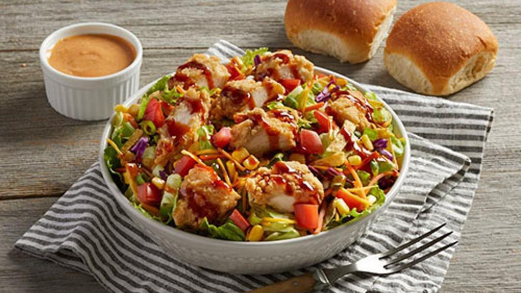 Bob Evans Wildfire® Chicken Salad · Fresh greens topped with Homestyle fried or grilled chicken, corn, diced tomato, crisp green onions, cheddar cheese, tortilla strips and a drizzle of Bob Evans Wildfire® sauce. Pairs well with Wildfire® ranch dressing and served with dinner rolls.