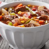 Hearty Beef Vegetable Soup · Tender beef cooked in a tomato broth loaded with carrots, corn, tomatoes, potatoes, celery a...