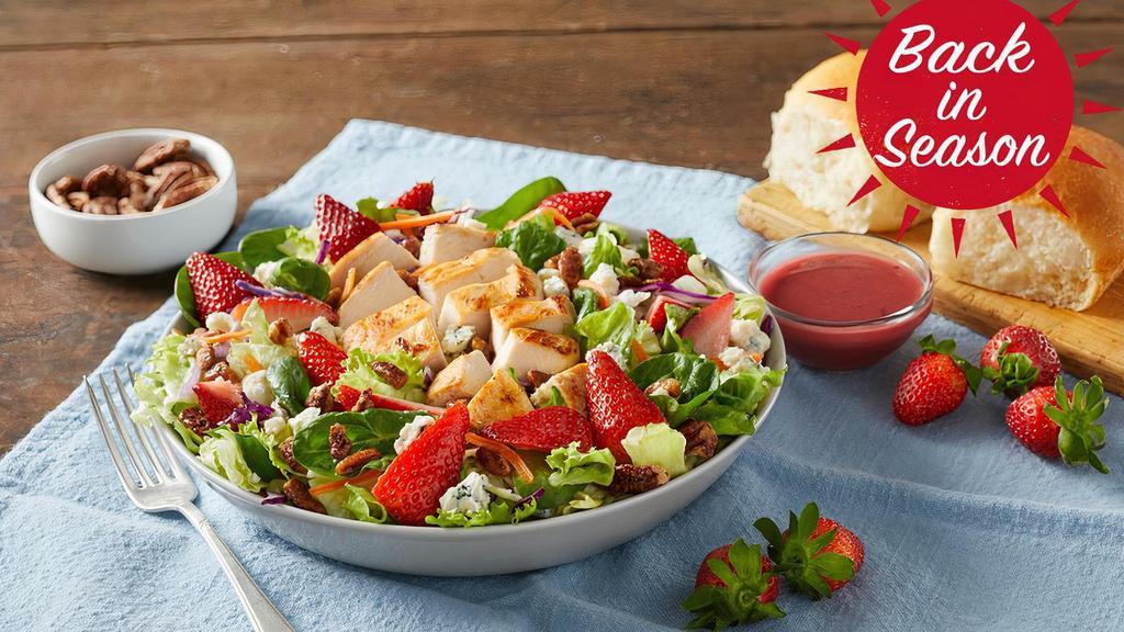 Summer Berry Salad · Enjoy a burst of vine-ripened strawberries with chicken grilled-to-perfection, pecans and real blue cheese on a bed of fresh greens. Served with our lite berry vinaigrette.