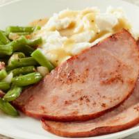 Hickory-Smoked Ham Steaks · Served with mashed potatoes, gravy and green beans