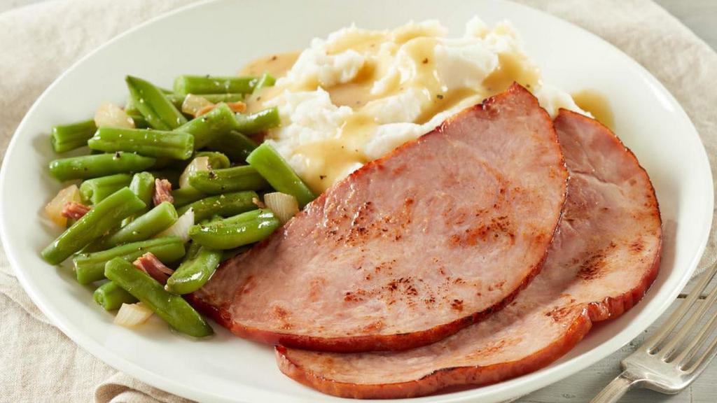 Hickory-Smoked Ham Steaks · Served with mashed potatoes, gravy and green beans