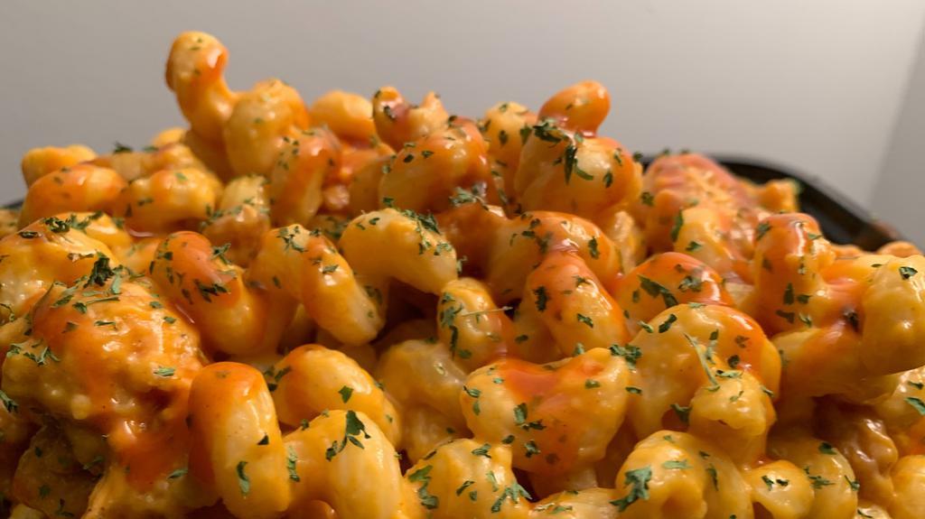 Buffalo Mac'N Cheez · Vegan. Cavatappi pasta with a house made creamy vegan cheez sauce (oat and soy based). Topped with crispy buffalo soy protein. With chorizo.