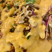 Loaded Nachos · Nachos topped soy based chorizo, rice, black beans, corn, pico de gallo and vegan nacho cheese
