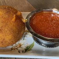 Arancini · Rice ball, with saffron, beef, ragu, with peas and tomato sauce.