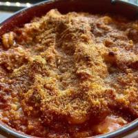 Anelletti Al Forno · Oven-baked anelletti pasta, white sauce ragu, mozzarella & parmigiano cheese.
