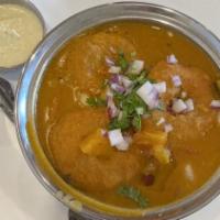 Vada In Sambar · Mini vada soaked in sambar with ghee.