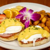 Eggs Benedict · Two poached farm fresh eggs over canadian bacon, on a toasted english muffin, topped with a ...
