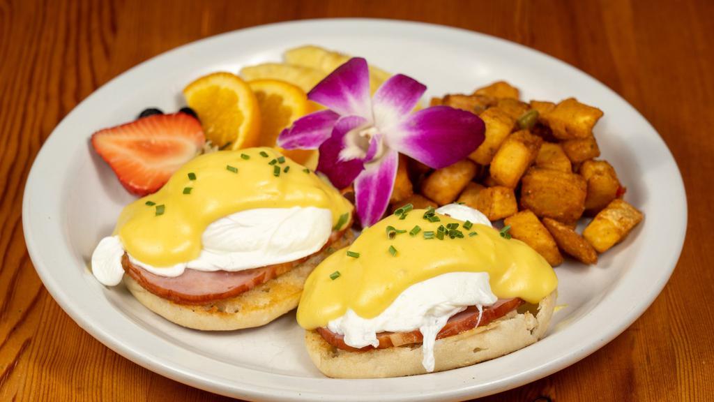 Eggs Benedict · Two poached farm fresh eggs over canadian bacon, on a toasted english muffin, topped with a light and airy hollandaise sauce.