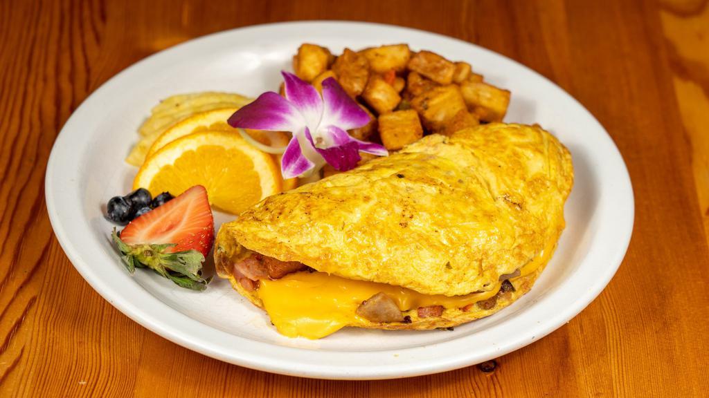 Farmers Omelette · Crispy bacon, sausage, ham, peppers, onions, home fries with melted american cheese and served with fresh fruit.