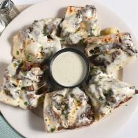 Steak Tidbits · Sauteed steak on garlic bread and baked with mozzarella. Comes with a side of gorgonzola cre...