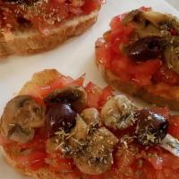 Bruschetta · Homemade Bread, Tomato Bruschetta, Melted Monterey Mozzarella Cheese & Balsamic Reduction