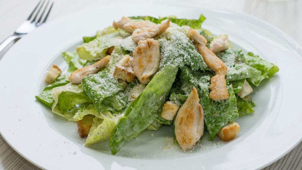 Chicken Caesar Salad · Grilled chicken served over lettuce, tomato, onions, shaved Parmesan cheese, and Caesar dressing.