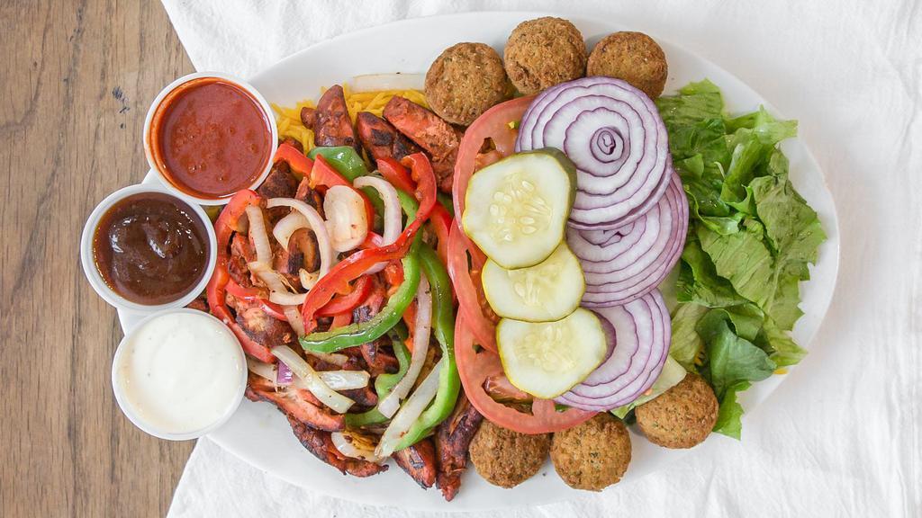 Combo Chicken ,Lamb & Falafel Over Rice & Salad · Mix grilled boneless chicken and lamb with grilled onion and peppers over rice and cucumber salad with two falafel balls served with your choice of sauce.